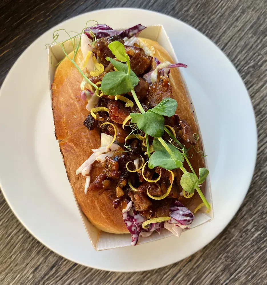 Pulled pork bagel with microgreens and lemon zest