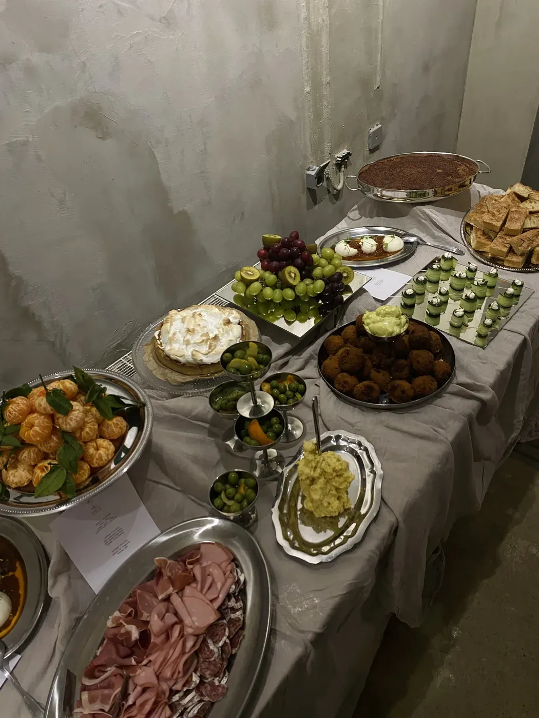 Catering buffet with falafel, pavlova, oranges, and seasonal dishes