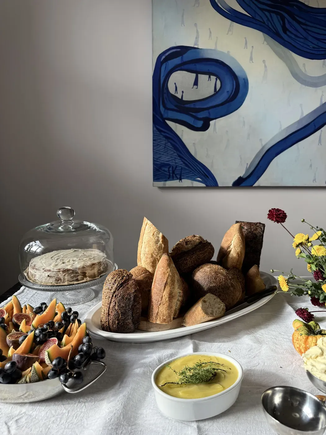 Artisan bread, figs, and soup on a beautifully set table