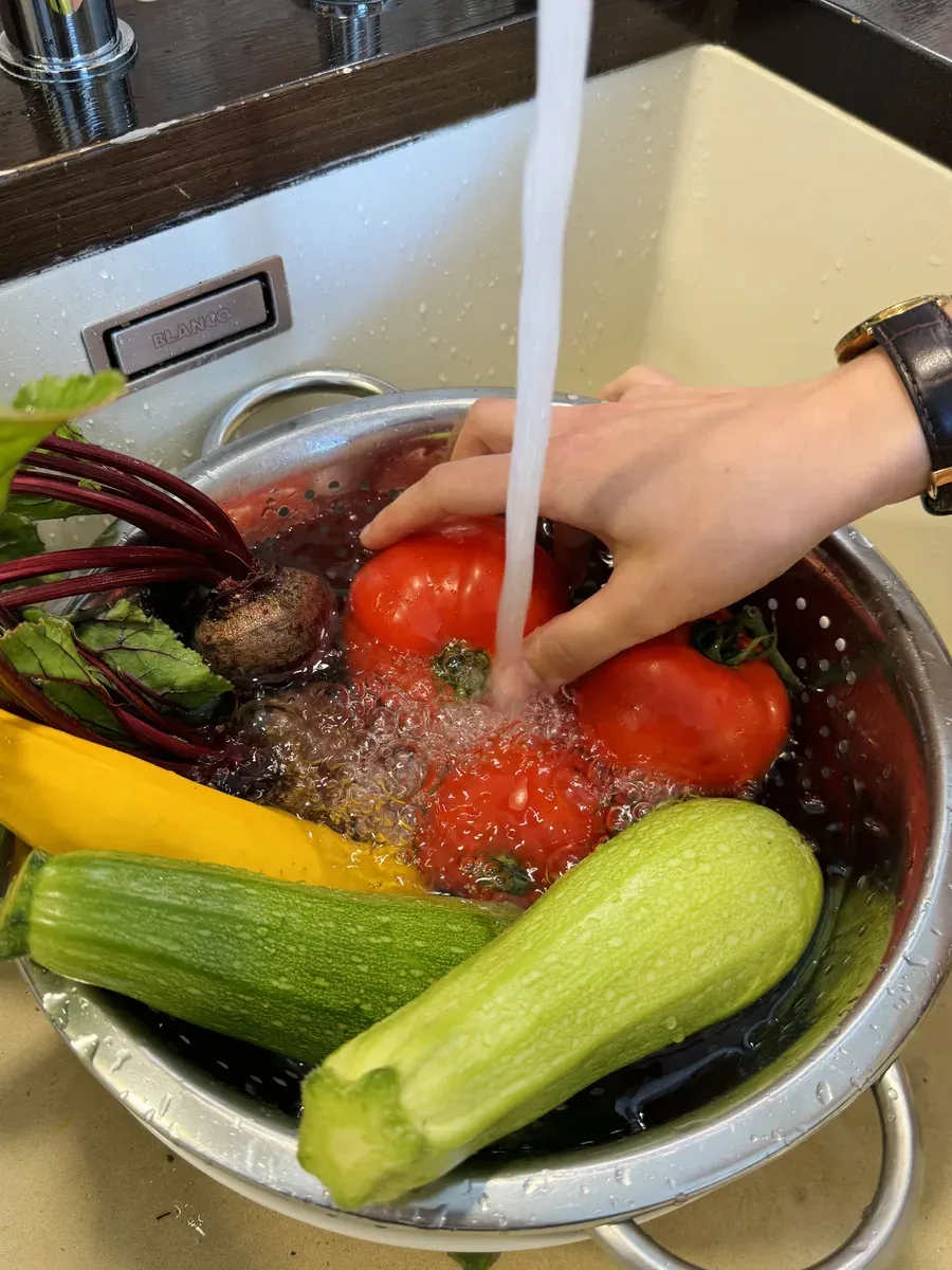 Washing fresh vegetables under running water